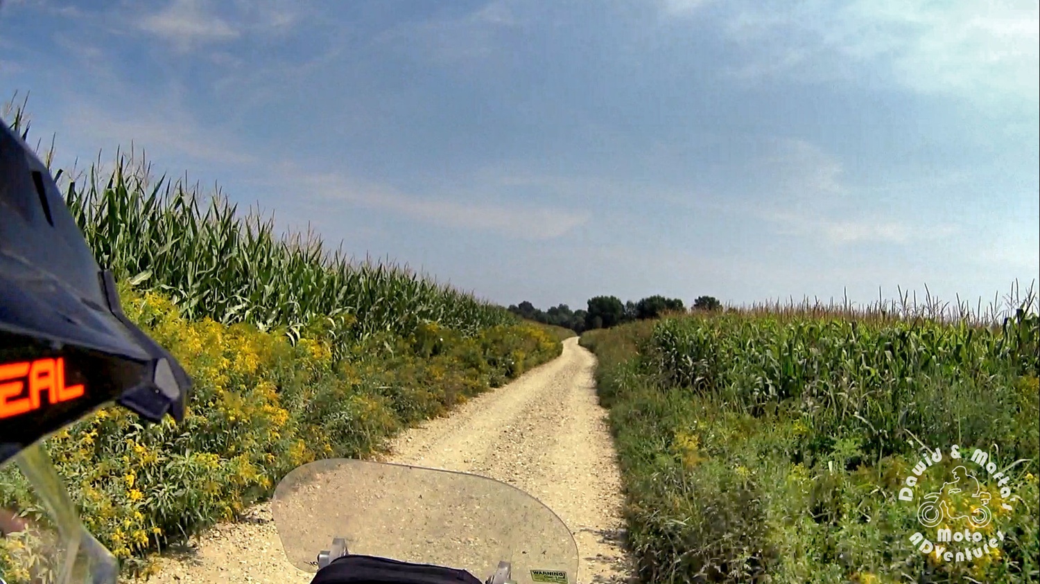 Leaving camping at the Drava River and riding offroad through the gravel road leading by the corn fields