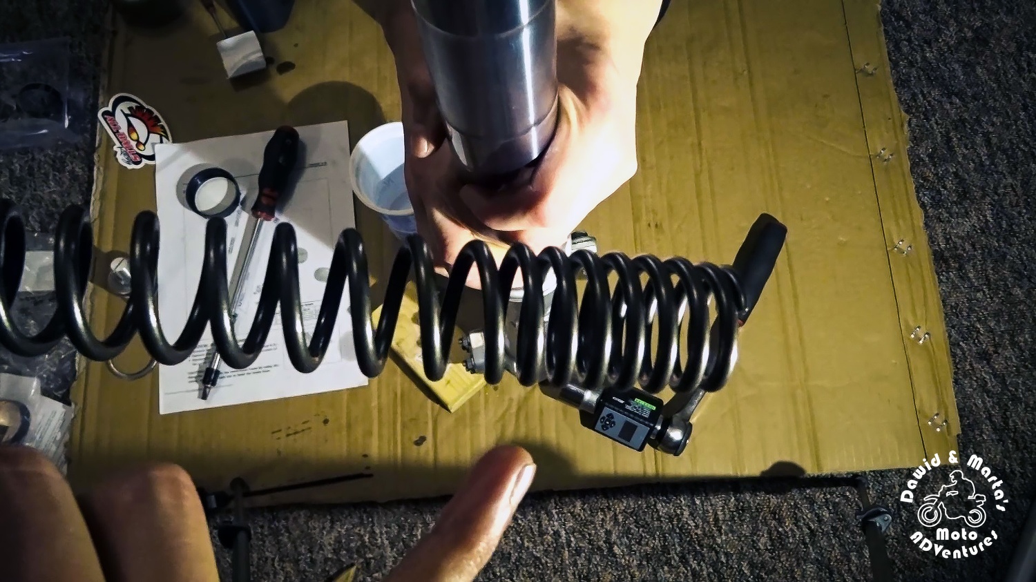 Inserting the front fork spring back to the tube